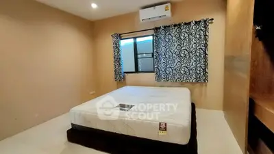 Cozy bedroom with stylish curtains and air conditioning unit