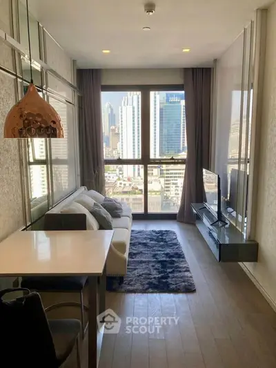 Modern living room with city view, stylish decor, and natural light in high-rise apartment.