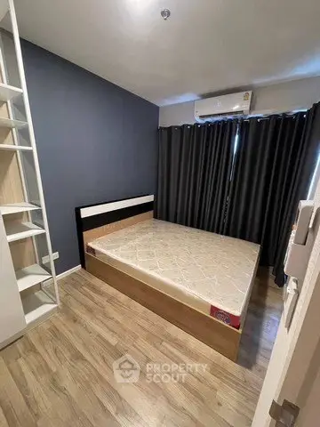 Modern bedroom with sleek design, featuring a comfortable bed and stylish shelving, perfect for urban living.