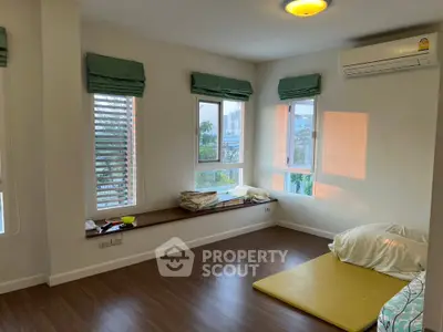 Spacious bedroom with large windows and natural light