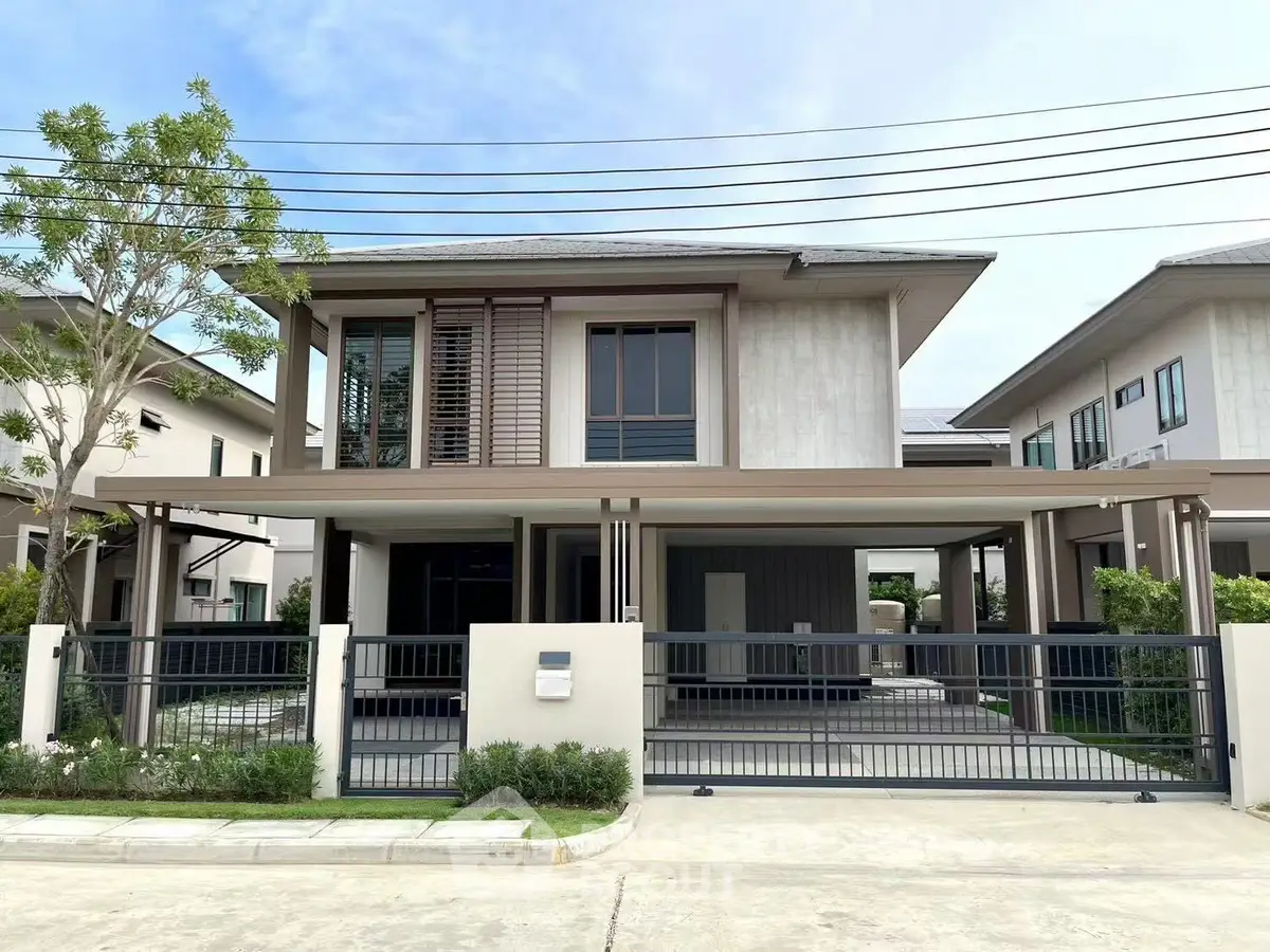 Modern two-story house with sleek design and spacious driveway in a suburban neighborhood.
