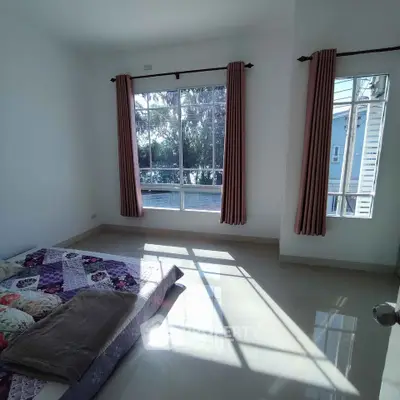 Spacious bedroom with large windows and natural light