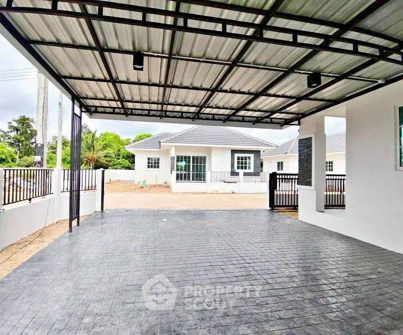 Spacious covered parking area with modern design in a suburban home setting.