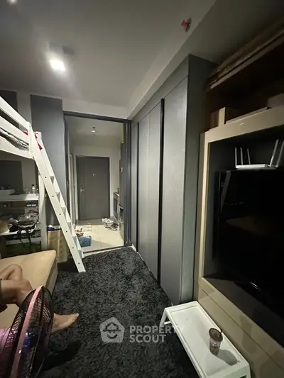 Cozy modern living space with loft bed and sleek storage solutions