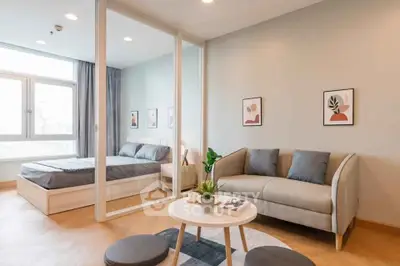 Modern studio apartment with cozy living area and stylish bedroom, featuring elegant decor and natural light.