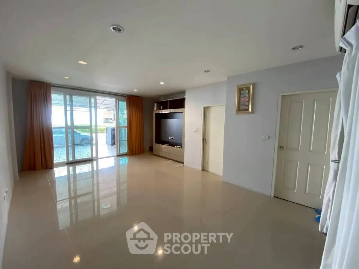 Spacious living room with modern design and large windows for natural light.