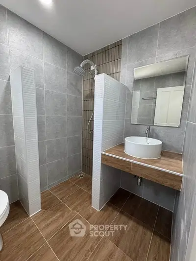 Modern bathroom with sleek design, featuring a walk-in shower and stylish vanity.