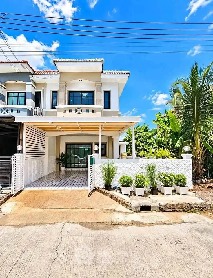 Charming two-story house with modern facade and lush garden in a serene neighborhood.