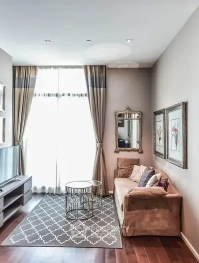 Elegant living room with plush sofa, stylish decor, and large window draped with curtains.