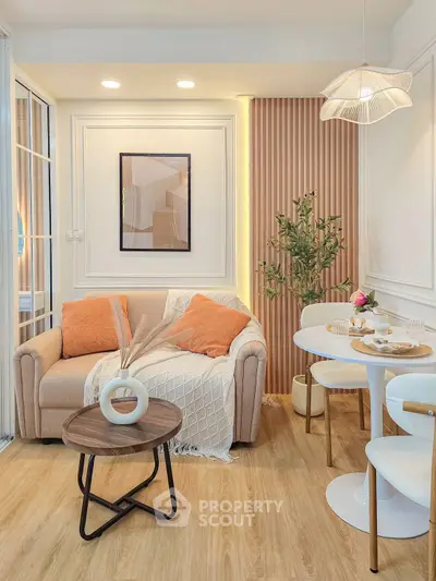 Charming living room with cozy sofa, stylish decor, and elegant dining area, perfect for modern living.