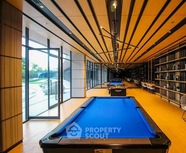 Luxurious game room with pool tables and modern design in upscale residential building.