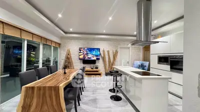 Modern open-layout kitchen with sleek appliances and stylish dining area