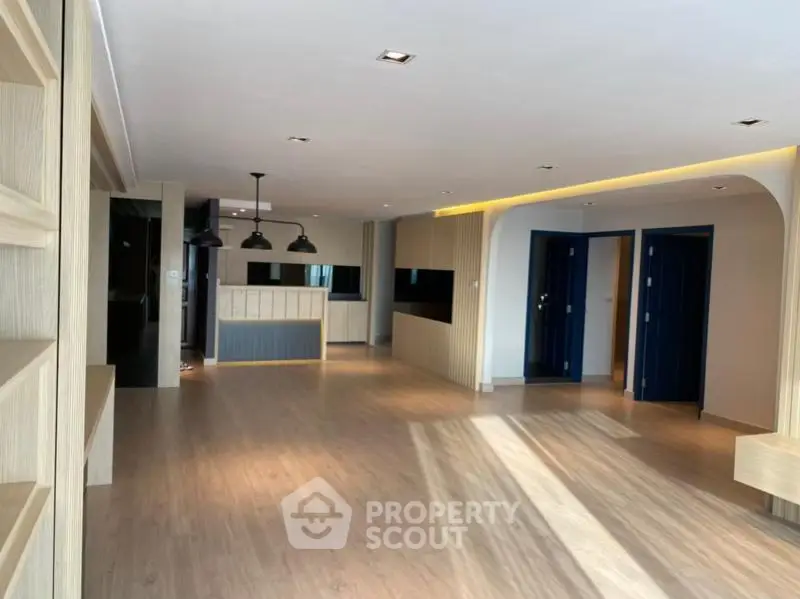 Spacious modern living room with open layout and stylish lighting