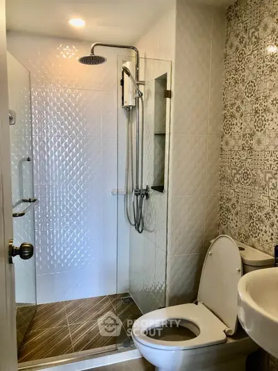 Modern bathroom with glass shower and stylish tile design
