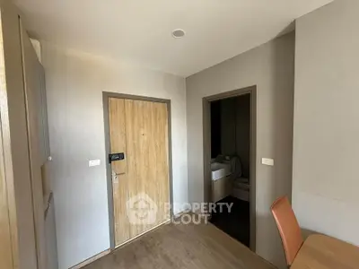 Modern apartment entrance with wooden door and sleek interior design