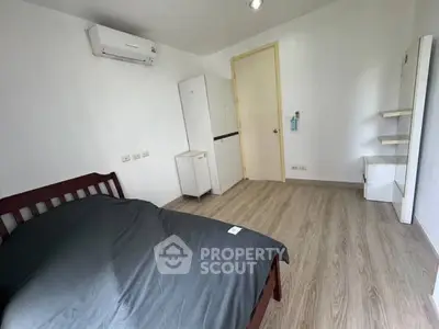 Spacious bedroom with modern decor and wooden flooring