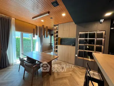 Luxurious modern dining area with wooden accents and large windows in a stylish home.