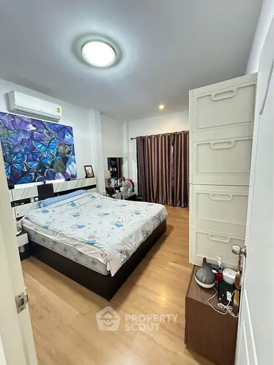 Cozy bedroom with modern decor and ample natural light