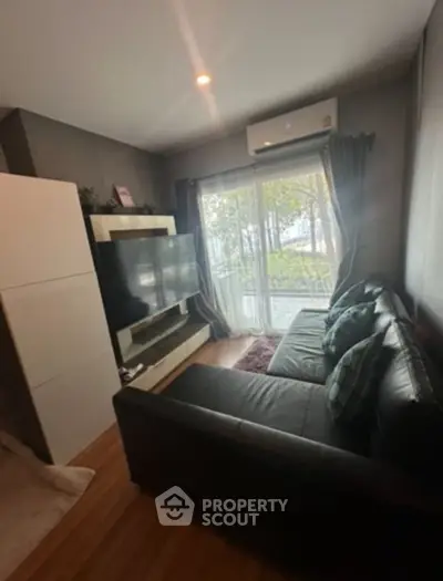 Cozy living room with large window and modern decor