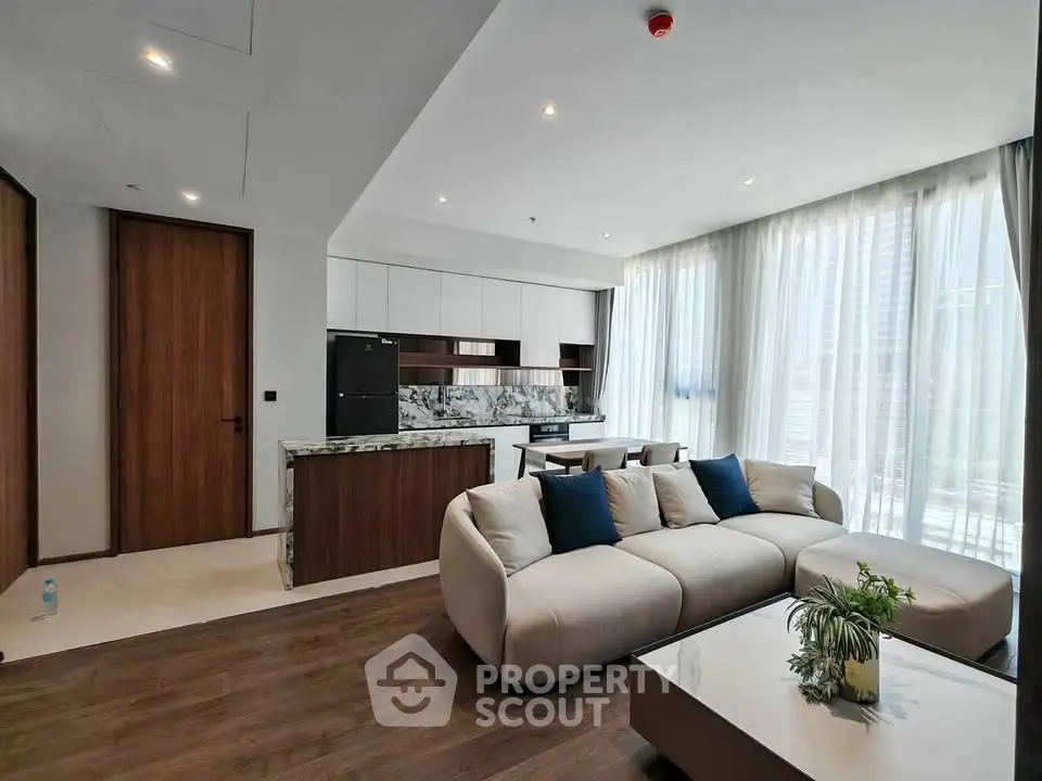 Modern living room with elegant decor and large windows in a luxury apartment.