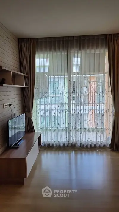 Bright living room with floor-to-ceiling windows and modern decor.