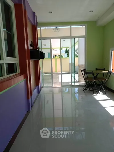 Bright interior with colorful walls and glass doors leading to a patio