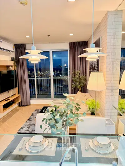 Modern living room with city view, stylish decor, and elegant lighting in a high-rise apartment.