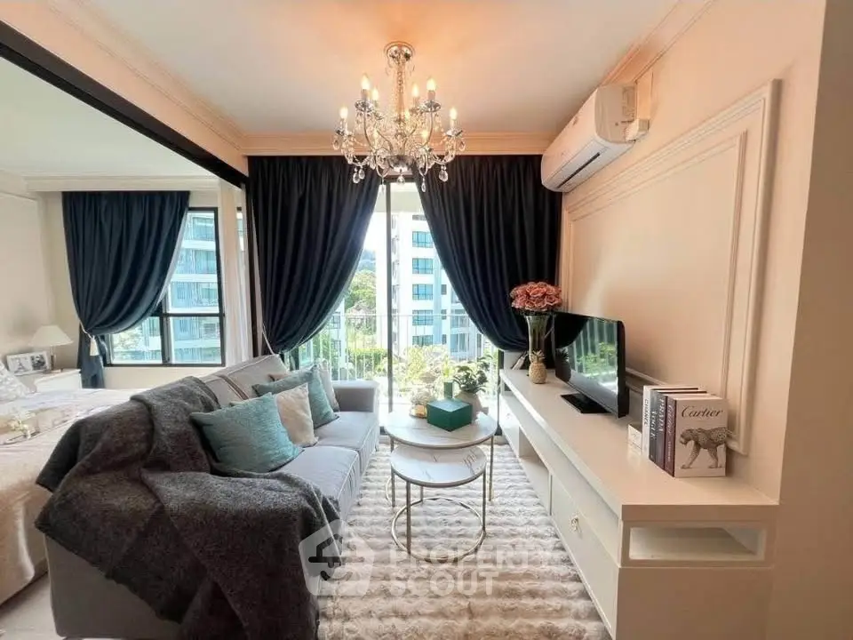 Luxurious living room with elegant chandelier and modern decor in a high-rise apartment.