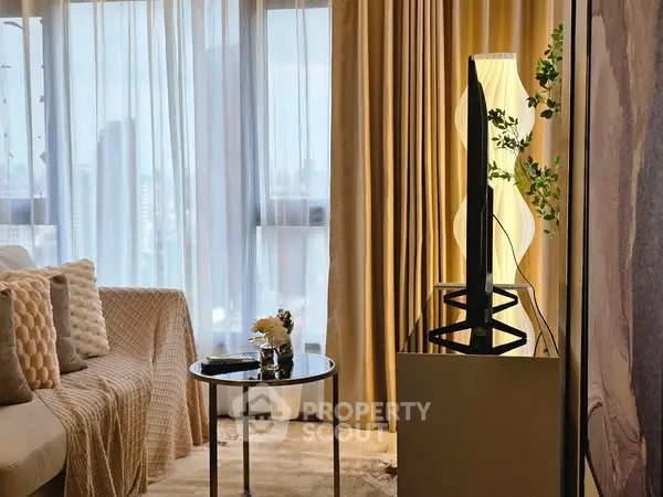 Elegant living room with modern decor and city view, featuring stylish lighting and plush seating.