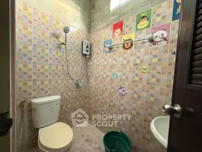 Charming bathroom with colorful tiles and modern shower setup