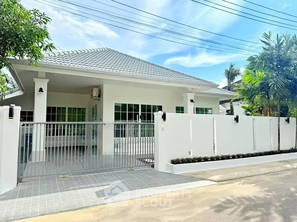 Charming single-story home with modern design and spacious driveway in a serene neighborhood.