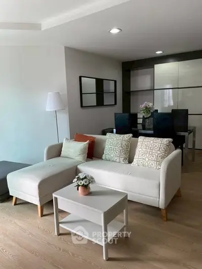 Modern living room with stylish sofa and dining area, perfect for relaxation and entertaining.