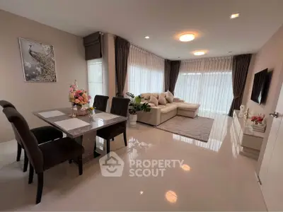 Elegant living room with modern dining area and cozy seating, perfect for relaxation and entertainment.