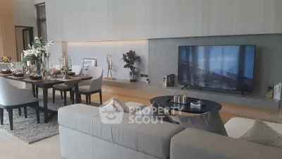 Luxurious modern living room with elegant dining area and large TV
