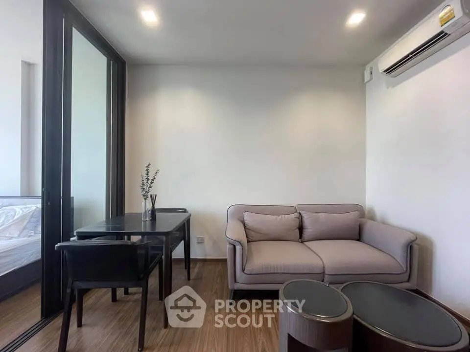 Modern living room with cozy sofa and dining area in stylish apartment