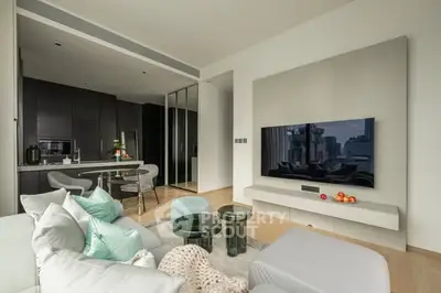 Modern living room with open kitchen, sleek design and city view.