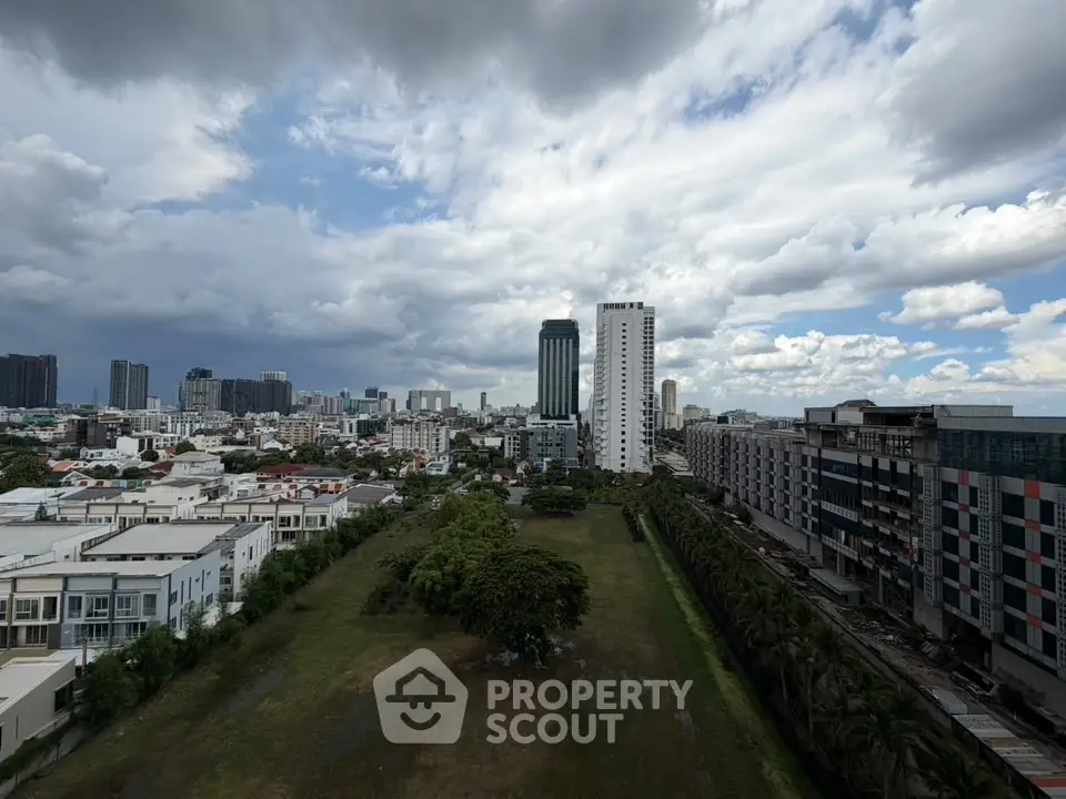 Stunning cityscape view with modern high-rise buildings and lush greenery, perfect for urban living.