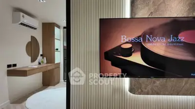 Modern living room with stylish decor and wall-mounted TV playing Bossa Nova Jazz.