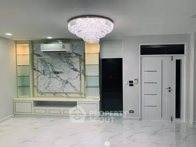 Luxurious modern living room with marble accents and elegant chandelier