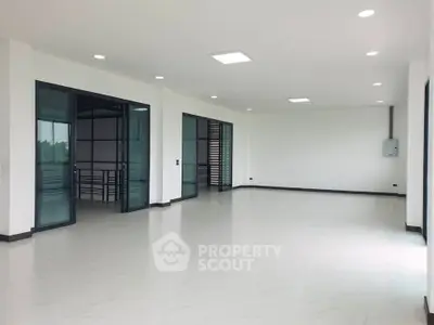 Spacious modern interior with large windows and sleek flooring