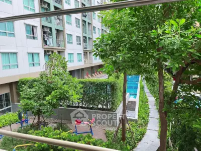 Modern apartment complex with lush garden and inviting swimming pool view.