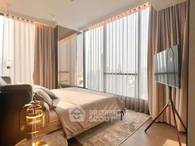 Luxurious bedroom with floor-to-ceiling windows and modern decor in a high-rise apartment.