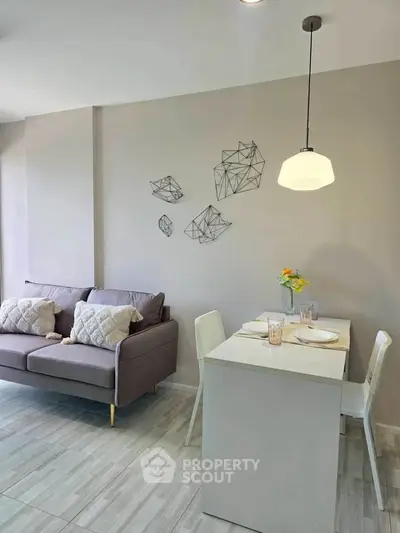 Modern living room with stylish decor and cozy dining area, perfect for urban living.