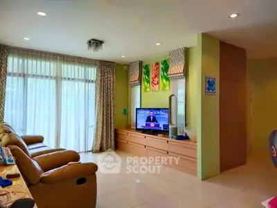 Spacious living room with modern decor and large windows for natural light.