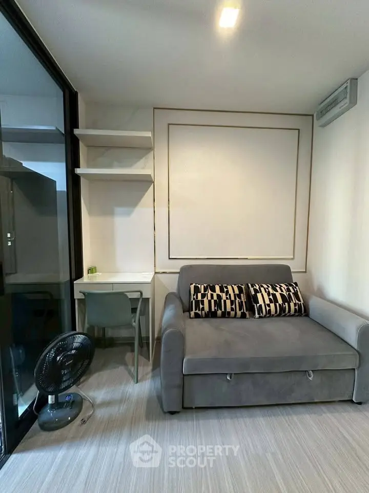 Modern living room with stylish sofa and workspace in cozy apartment