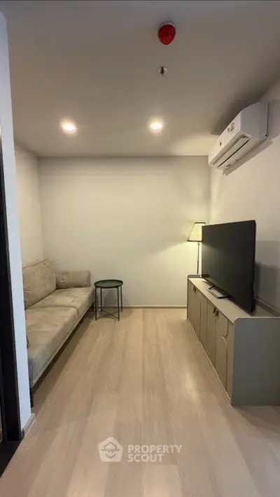 Modern living room with sleek furniture and ambient lighting, perfect for cozy relaxation.