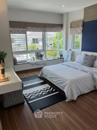 Chic bedroom with large windows and stylish decor in modern home