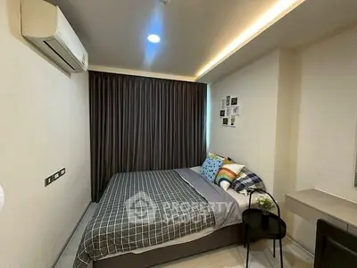 Cozy bedroom with modern decor and air conditioning in a stylish apartment.