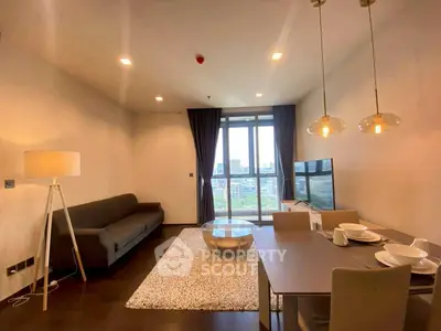 Modern living room with city view, stylish decor, and cozy ambiance.