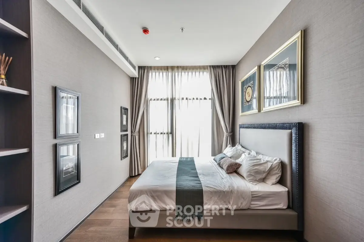 Luxurious modern bedroom with elegant decor and large window for natural light.